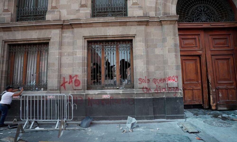 Manifestantes derriban puerta de Palacio Nacional en apoyo a padres de los 43 de Ayotzinapa